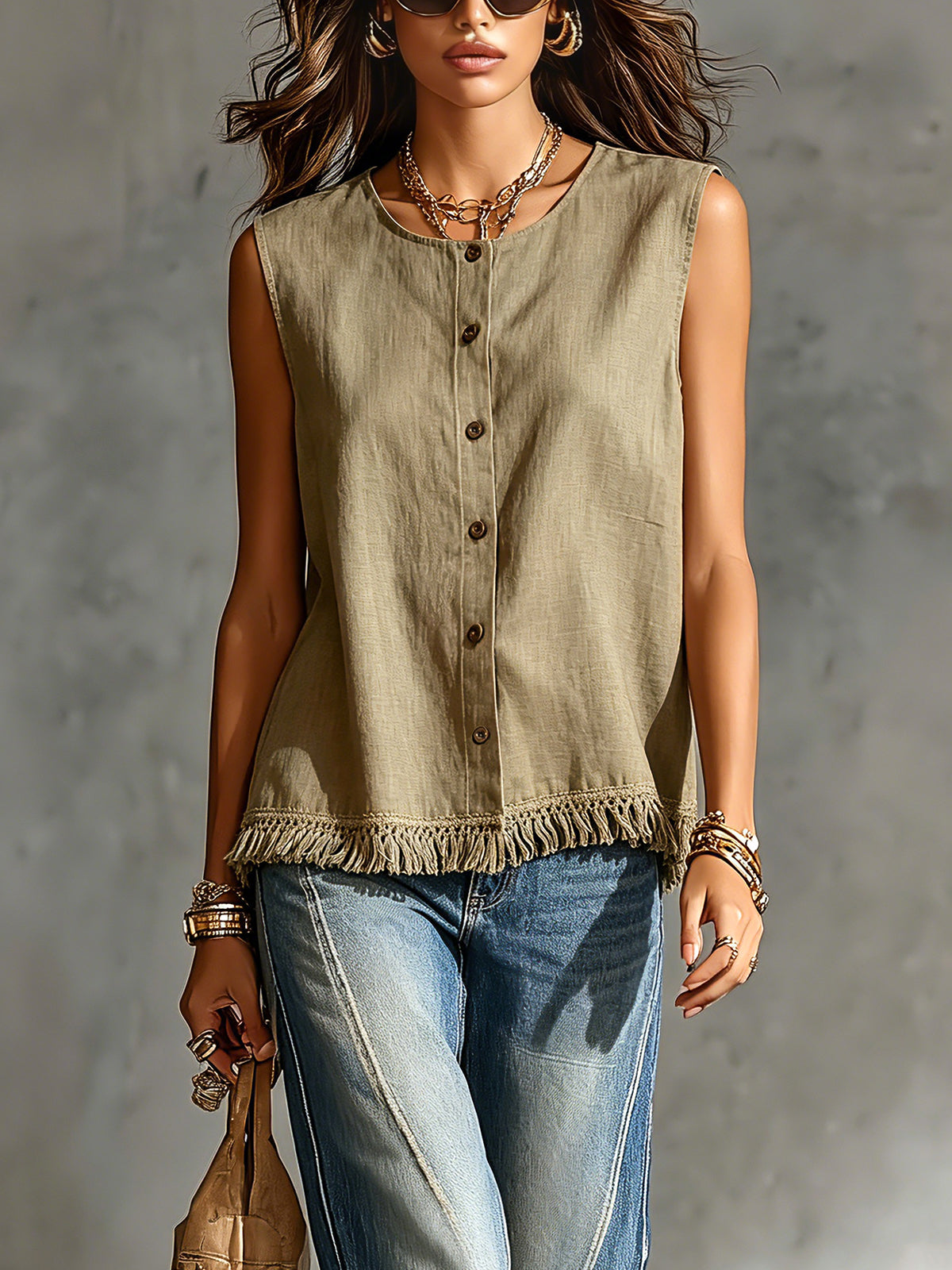 Woman wearing a sleeveless green top and blue jeans against a gray background