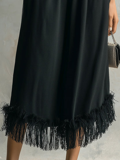 Black fringe dress on a neutral background