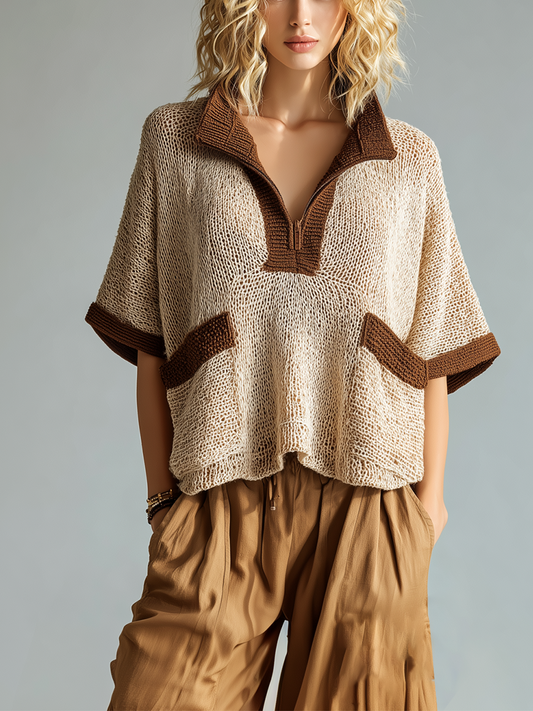 Woman wearing a beige knitted top with brown trim and matching pants on a gray background
